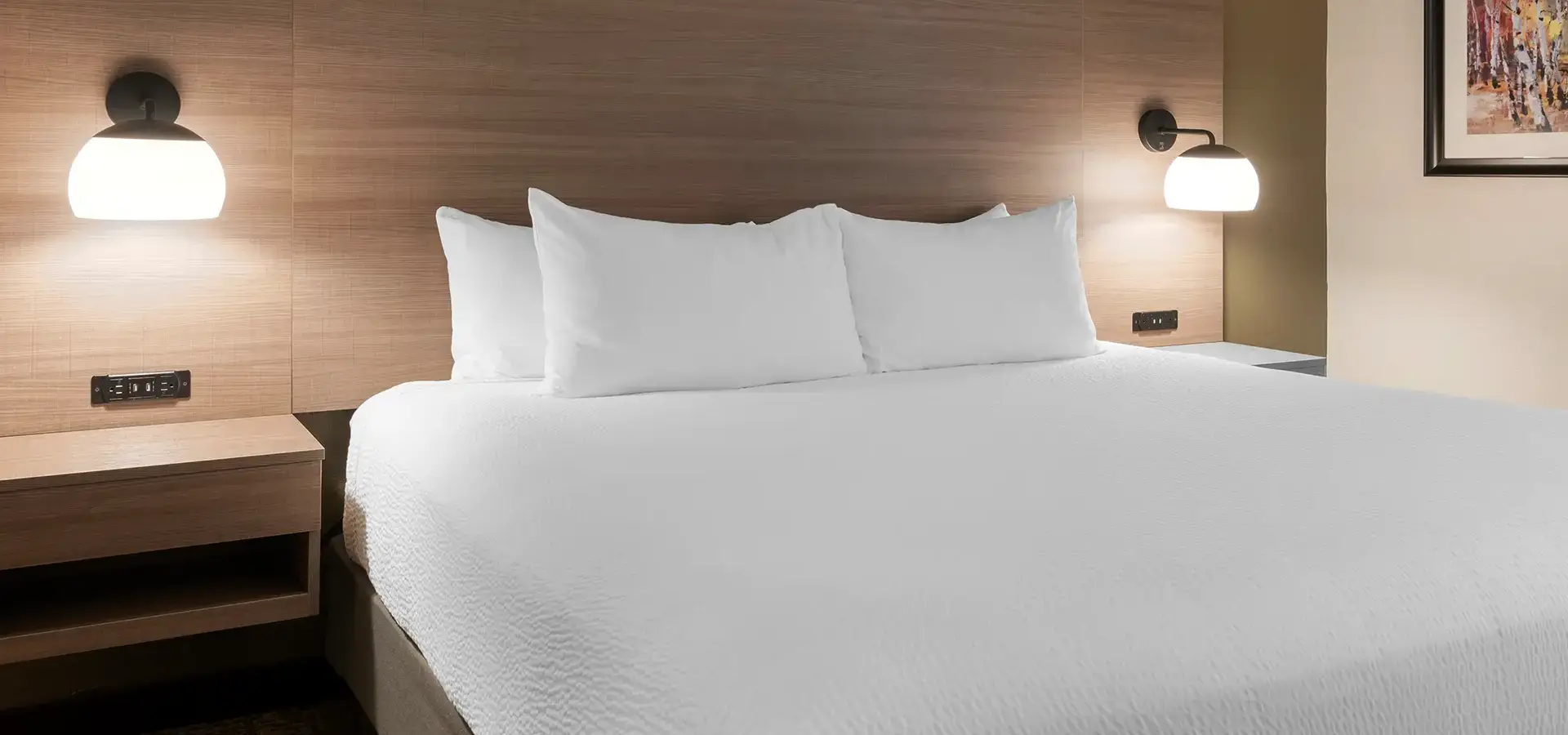 Modern guest room with king bed and warm lighting at Best Western Plus Windjammer Inn & Conference Center